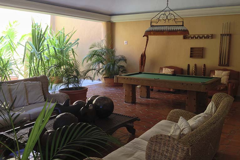 Sala de juegos con mesa de billar y tv.